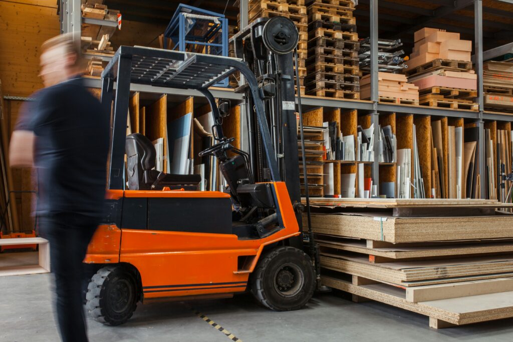 Forklift moving through a commercial supply warehouse